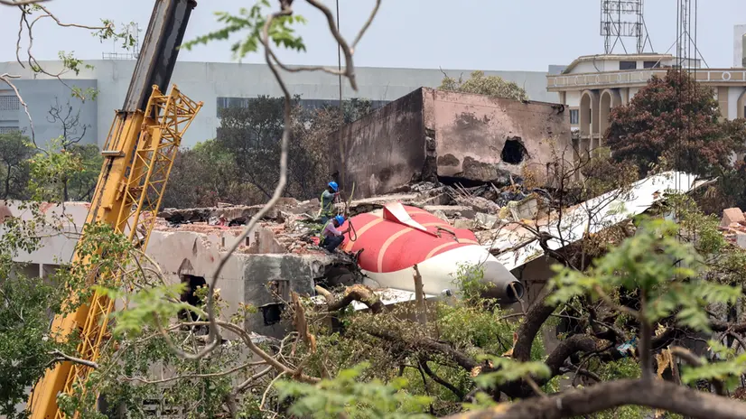 epa12174658 Officials inspect the remains of the Air India passenger plane at the crash site near Sardar Vallabhbhai Patel International Airport in Ahmedabad, Gujarat state, western India, 14 June 2025. Air India flight AI171, bound for London carrying 242 passengers and crew members on board a Boeing 787-8 aircraft, crashed minutes after take-off in the Meghaninagar area of Ahmedabad on 12 June. EPA/RAJAT GUPTA