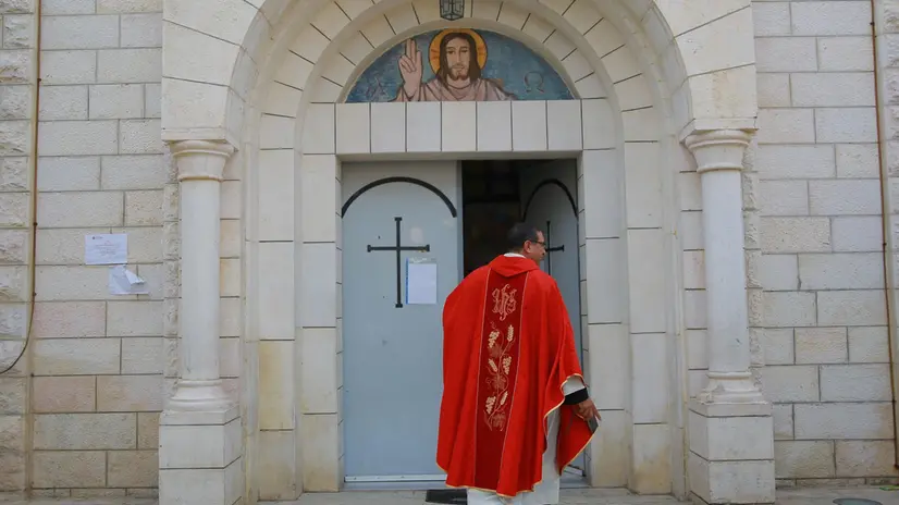 A Palestinian priest arrives at the Holy Family church to attend the Good Friday mass in the Al-Zaytoun neighbourhood of Gaza City on March 29, 2024, amid the ongoing conflict between Israel and the Hamas militant group. (Photo by AFP)