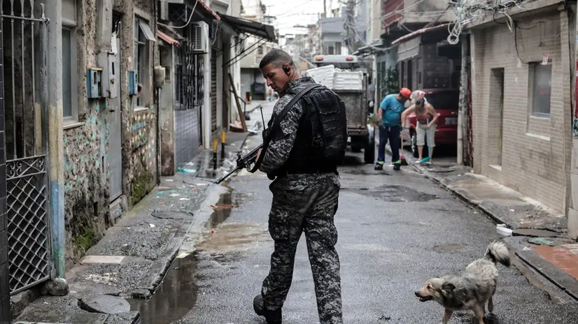 epa10909713 A police officer participates in an operation against criminal gangs in a favela in Rio de Janeiro, Brazil, 09 October 2023. Nearly 1,000 police officers were deployed in three of the most violent favelas in Rio de Janeiro in a mega-operation with which authorities seek to catch leaders of the Red Command, one of the most dangerous criminal organizations in Brazil, official sources reported. The actions took place in Complexo da Mare, Vila Cruzeiro and Cidade de Deus, where the agents seek to fulfill 100 arrest warrants, according to the secretary of the Civil Police of the state of Rio de Janeiro, Jose Renato Torres, in a press conference. EPA/Antonio Lacerda