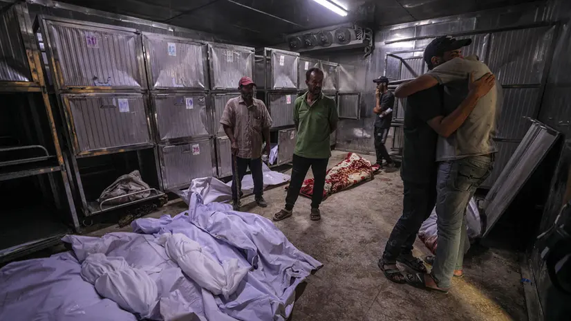 epa12238933 Palestinians mourn over dead bodies at the Al-Shifa hospital after an Israeli air strike in Gaza City, 15 July 2025. The Palestinian Ministry of Health in Gaza said that more than 30 Palestinians were killed following Israeli air strike over night and early in the day. EPA/MOHAMMED SABER