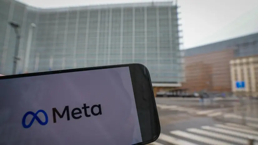 epa12048759 A Meta company logo on a phone in front of European Commission Headquarters as EU fines Apple 500 million Euro and Meta 200 million Euro for breaking Europe's digital rules in Brussels, Belgium, 23 April 2025. The European Commission on 23 April 2025 has fined Apple 500 million and Meta 200 million euros for breaching the Digital Markets Act (DMA). Apple was found to have breached its obligation to prevent anti-steering practices and Meta was found to have breached its obligation to offer consumers the choice of a service that uses less of their personal data. EPA/OLIVIER HOSLET