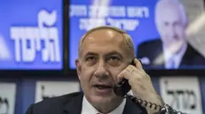 epa03541031 Israel's Prime Minister Benjamin Netanyahu speaks on the phone to Israeli citizens urging them to cast their votes for him in the upcoming Israeli elections in Tel Aviv, Israel, 17 January 2013. According to surveys Netanyahu is headed for his second consecutive and third in total term as Prime Minister. EPA/OLIVER WEIKEN