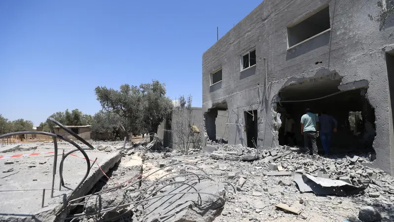 epa12243061 Relatives of late Palestinian youth Mohammad Nazzal inspect the damaged house in Qabatiya town, south of the West Bank city of Jenin, 17 July 2025. According to the Palestinian news agency Wafa, Israeli forces blew up three homes of the families of youths Wael Idris Lahlouh, Mohammad Nazzal, and Mohammad Zakarneh. EPA/ALAA BADARNEH