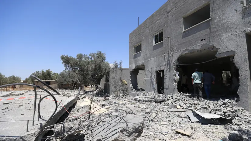 epa12243061 Relatives of late Palestinian youth Mohammad Nazzal inspect the damaged house in Qabatiya town, south of the West Bank city of Jenin, 17 July 2025. According to the Palestinian news agency Wafa, Israeli forces blew up three homes of the families of youths Wael Idris Lahlouh, Mohammad Nazzal, and Mohammad Zakarneh. EPA/ALAA BADARNEH