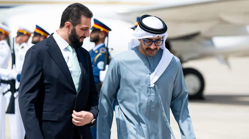 epa12222986 A handout photo made available by the UAE's Presidential Court shows United Arab Emirates Deputy Prime Minister and Minister of Foreign Affairs H.H. Sheikh Abdullah bin Zayed Al Nahyan (R) welcoms Syrian President Ahmed Al Sharaa (L) upon his arrival to Abu Dhabi, United Arab Emirates, 07 July 2025. EPA/THE UAE PRESIDENTIAL COURT /HANDOUT HANDOUT HANDOUT EDITORIAL USE ONLY/NO SALES