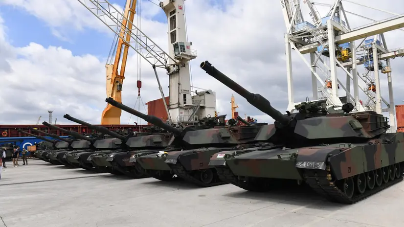 epa10715426 M1A1 Abrams tanks sit on the tarmac during the handover of the first batch of US tanks to the soldiers of the Polish Army in the port of Szczecin, Poland, 28 June 2023. 14 out of 116 purchased and modernized Abrams from the US Marine Corps have reached Poland. The tanks will become part of the equipment of the 18th Mechanized Division. EPA/Marcin Bielecki POLAND OUT