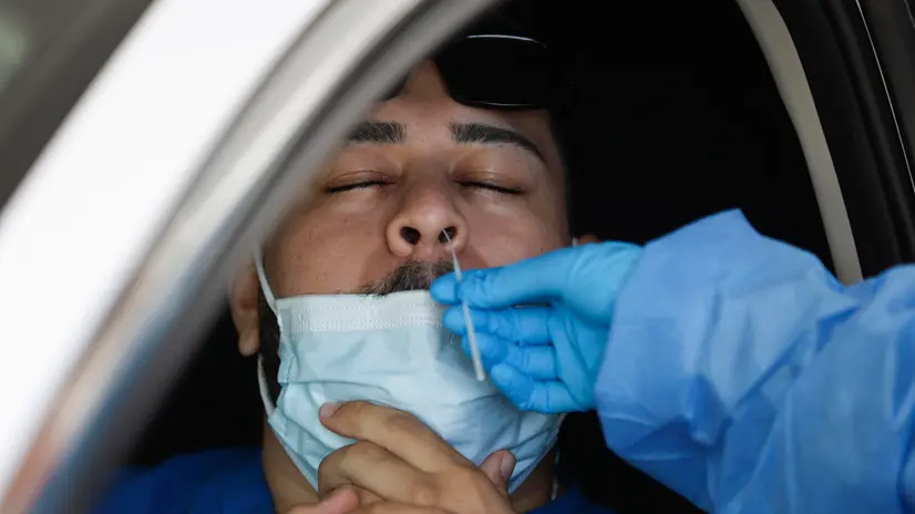 epa10832461 Healthcare worker Violet Estrada (R) takes a nasal swab sample to test for Covid-19 at a Total Testing Solutions Covid Testing Center in Los Angeles, California, USA, 31 August 2023. According to the Los Angeles County Department of Public Health, Covid-19 levels have risen for the fifth consecutive week in Los Angeles County. EPA/CAROLINE BREHMAN
