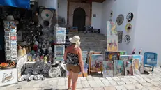 epa12212384 A Tourist visits the village of Sidi Bou Said, a popular tourist destination, in Tunis, Tunisia, 03 July 2025. The Director General of the Tunisian National Tourism Office (ONTT), Mohamed Mehdi Haloui, told the media that the 2025 tourist season looks promising, with over 3.4 million tourists arriving in Tunisia between 01 January and 31 May—an increase of 10.2 percent compared to the same period in 2024. He added that if this growth continues, Tunisia could reach its target of 11 million visitors in 2025, up from 10.26 million in 2024. EPA/MOHAMED MESSARA