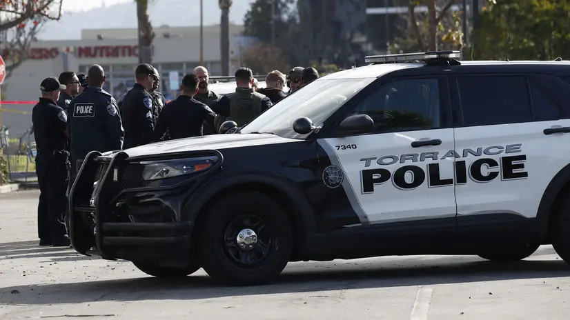 epa10423993 Police officers gather as investigators go through a white van which police reported was connected with a mass shooting at a dance studio in Monterey Park, California, after police entered the vehicle and found dead body in Torrance, California, USA, 22 January 2023. The shooting killed ten and wounded ten more during a Lunar New Year celebration according to the Los Angeles County Sheriff's Department. EPA/CAROLINE BREHMAN