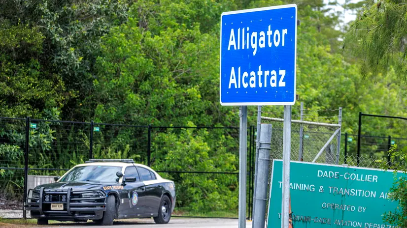 epa12238069 A police car guards the new detention center Alligator Alcatraz's entrance in Ochopee, Florida, USA, 14 July 2025. Alligator Alcatraz is an immigration detention facility in southern Florida's Everglades, surrounded by Everglade's wildlife like alligators, Florida panthers and pythons, and snakes as a natural deterrent. EPA/CRISTOBAL HERRERA-ULASHKEVICH