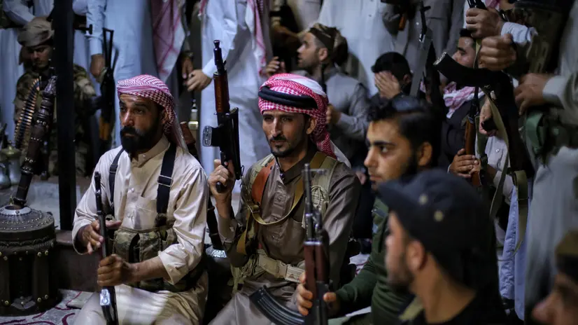 epa12244490 Armed men gather inside the Syrian Tribes and Clans Council headquarters in Idlib, Syria, 18 July 2025 during the announcement of the general mobilization in support of Bedouin tribes in Sweida. The council announced a general mobilization, stating that some of its members had begun moving south to “support the Bedouin tribes” amid ongoing tensions and clashes in the region. EPA/BILAL AL HAMMOUD