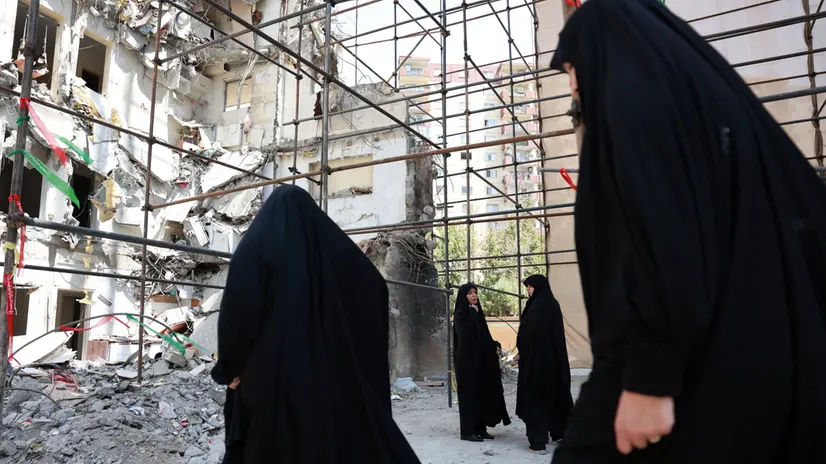 epa12246883 Iranian women gather to inspect the damaged Chamran residential complex, hit by an Israeli airstrike during the 12-days conflict between Israel and Iran, in Tehran, Iran, 19 July 2025. At least 60 people, including dozens of children, were killed in the airstrike on the military residential complex on 13 June. A US-mediated ceasefire came into effect on 24 June, ending the escalation of the conflict between Iran and Israel that had begun on 13 June. EPA/ABEDIN TAHERKENAREH