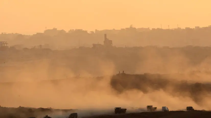 epa12249993 A convoy of Israeli soldiers drives following an Israeli airstrike in the northern Gaza Strip near Beit Hanoun, as seen from the Israeli side of the border with the Gaza Strip, in southern Israel, 20 July 2025. EPA/ABIR SULTAN