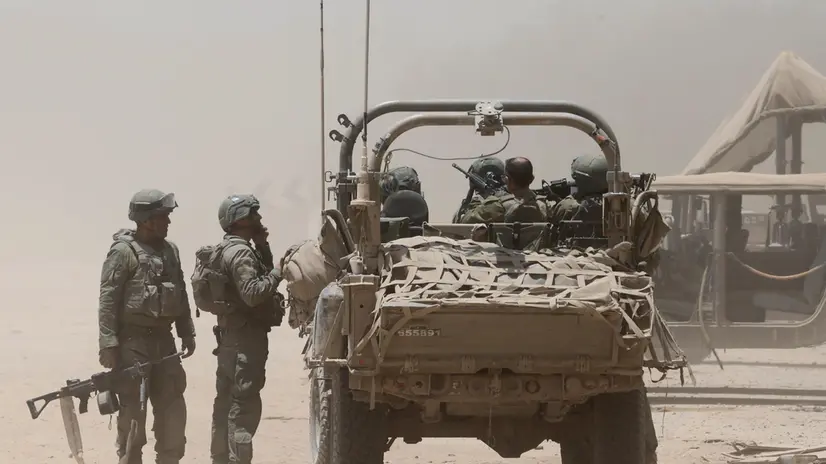 epa11452020 Israeli soldiers with a military vehicle at an undisclosed location near the border with the Gaza Strip, southern Israel, 02 July 2024. The Israeli military stated on 02 July that it continued operations in the areas of Shejaiya, Rafah, and central Gaza. More than 37,000 Palestinians and over 1,400 Israelis have been killed, according to the Palestinian Health Ministry and the Israel Defense Forces (IDF), since Hamas militants launched an attack against Israel from the Gaza Strip on 07 October 2023, and the Israeli operations in Gaza and the West Bank which followed it. EPA/ABIR SULTAN