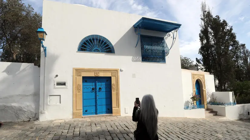 epa11910321 A tourist takes a photo of a house in the village of Sidi Bou Said, a renowned tourist destination celebrated for its white and blue hues, narrow alleys, traditional doors, and breathtaking views of the Mediterranean Sea, situated northeast of Tunis, Tunisia, 20 February 2025. According to Soufiane Tekaya, the Tunisian Minister of Tourism and Handicrafts, Tunisia received a record-breaking 10.25 million foreign tourists in 2024, surpassing pre-pandemic figures, and is expected to welcome over 11 million tourists in 2025. EPA/MOHAMED MESSARA 76810