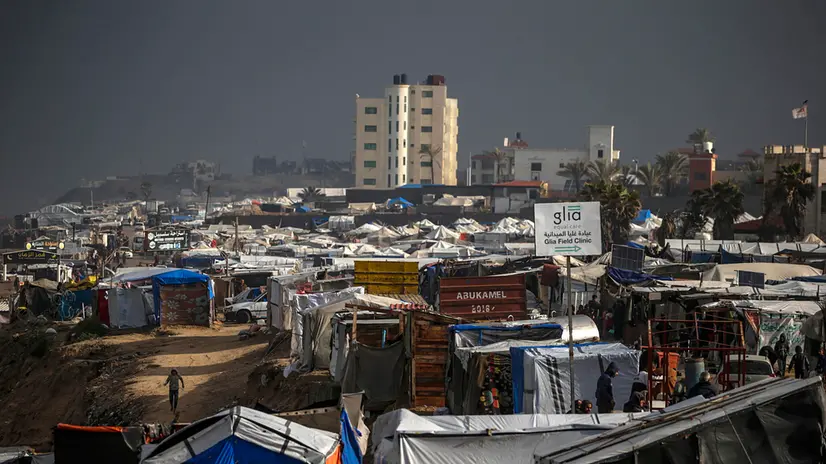 epa11798810 ​Internally displaced Palestinians walk outside their tents on a windy day west of Deir Al Balah, central Gaza Strip, 30 December 2024. According to the UN, at least 1.9 million people (or nine in ten people) across the Gaza Strip are internally displaced, including people who have been repeatedly displaced. Since October 2023, only about 11 per cent of the Gaza Strip has not been placed under Israeli-issued evacuation orders, the United Nations Office for the Coordination of Humanitarian Affairs (OCHA), said. EPA/MOHAMMED SABER