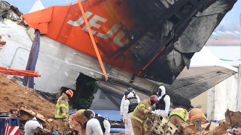 epa11804616 Forensic experts, police investigators and firefighters work at the site of a deadly plane crash at Muan International Airport, in Muan, southwestern South Korea, 04 January 2025. A Jeju Air passenger plane crashed into a localizer, a navigation system that assists in aircraft landings, at the airport on 29 December 2024, killing all but two of the 181 people onboard. EPA/YONHAP