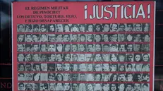 epa09051427 General view of a poster calling for justice with photographs of detainees who disappeared during the military dictatorship of Augusto Pinochet (1973-1990) in the Museum of Memory and Human Rights, in Santiago, Chile, 03 March 2021 (issued 04 March 2021). 30 years ago, the Chilean State apologized for the crimes of the military dictatorship of Augusto Pinochet (1973-1990), promoting democratic transition and citizen reconciliation. On 04 March 1991, then-President Patricio Aylwin (1990-1994), the first to take office during the democratic transition, addressed Chileans through a television message and on behalf of the State asked 'forgiveness from the families of the victims' of Pinochet, after reading the so-called 'Rettig Report', which officially recognized for the first time the systematic violations of Human Rights perpetrated for 17 years by State agents. EPA/Alberto Valdes