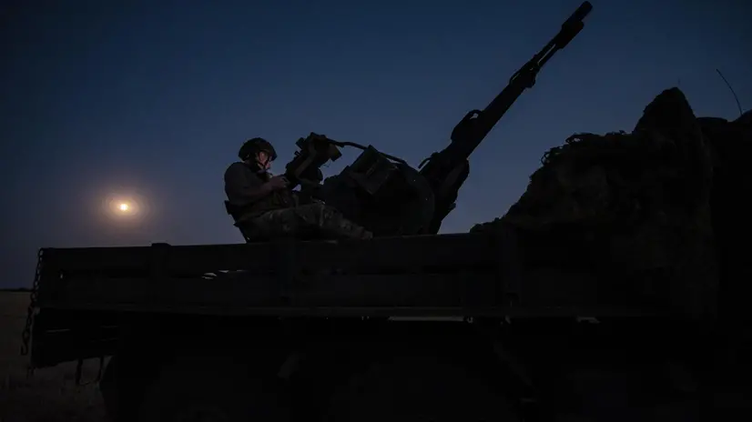 epa12227138 Two soldiers from a Ukrainian Army anti-aircraft artillery brigade scan their sector for Shahed drones on Ukraine's southern frontline on the night Russia launched the largest combined airstrike since it began its full-scale invasion of Ukraine, 08 July 2025. The unit operates a truck-mounted ZU-23-2 air defence system with a twin 23-calibre gun capable of targeting objects flying below 2,500 metres. EPA/Maria Senovilla