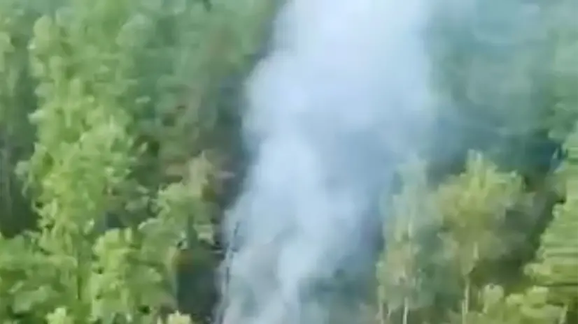 epa12257902 A still image taken from a handout video made available by the Ministry of Emergency Situations of Russia for the Amur Region shows smoke rises from the plane crash site of an An-24 passenger plane of Angara Airline in far east Amur region, Russia, 24 July 2025. A Russian An-24 passenger plane of Angara Airline crashed with 40 passengers in the far east Amur region, Russian Ministry of Emergencies said. EPA/RUSSIAN MINISTRY OF EMERGENCY SITUATIONS / HANDOUT HANDOUT BEST QUALITY AVAILABLEHANDOUT EDITORIAL USE ONLY/NO SALES