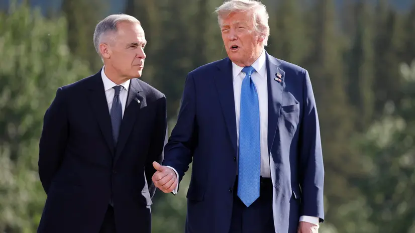 epa12180138 (L-R) Canadian Prime Minister Mark Carney and US President Donald Trump talk during a family photo at the Group of Seven (G7) Summit at the Kananaskis Country Golf Course in Kananaskis, Alberta, Canada, 16 June 2025. World leaders are gathered from 15 to 17 June 2025 for the annual G7 Summit. EPA/LUDOVIC MARIN / POOL