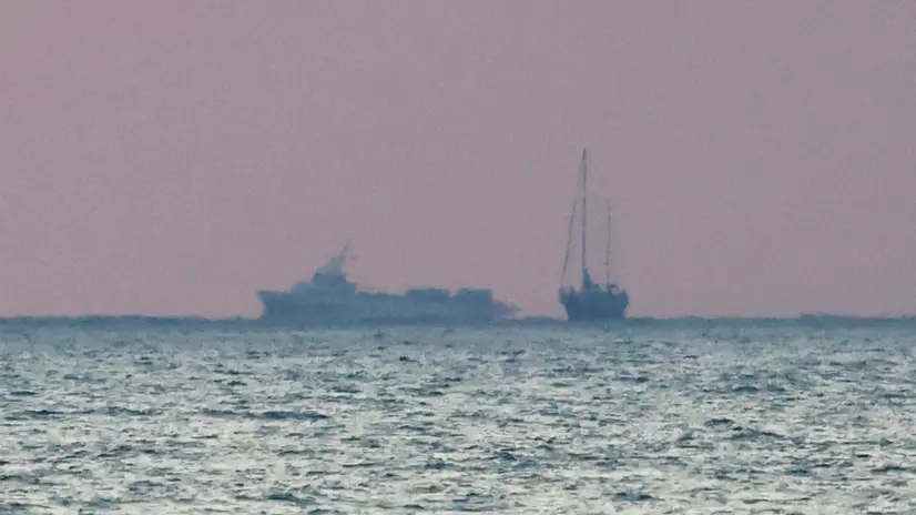 epa12166651 Israeli Navy vessels escort the ship Madleen (R) to the port of Ashdod, Israel, 09 June 2025. Israeli Navy intercepted the Gaza-bound Freedom Flotilla Coalition (FFC) ship Madleen carrying a small shipment of humanitarian aid in international waters on 09 June 2025. Israeli authorities said the flotilla was prevented from breaking a Gaza Strip blockade and was escorted to Israel's port of Ashdod, adding that its passengers were expected to return to their home countries. EPA/ABIR SULTAN
