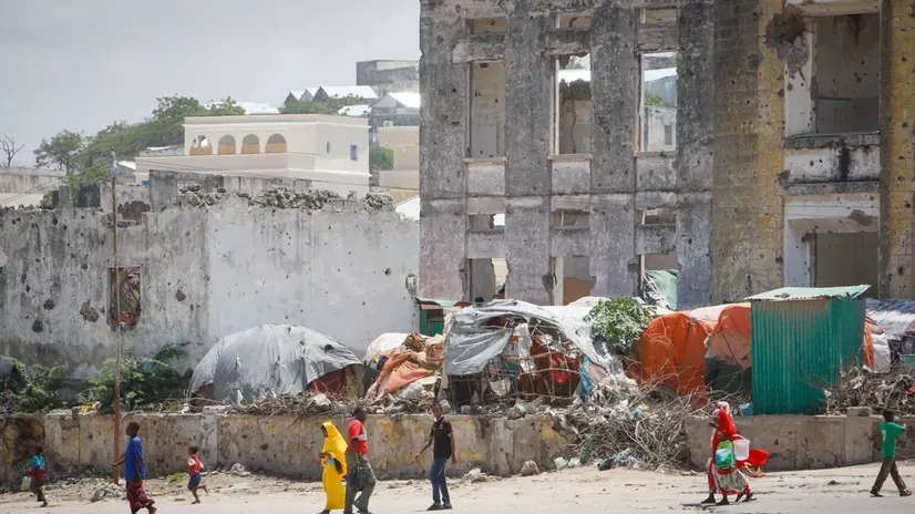 epa03814473 A handout photograph provided by the African Union-United Nations Information Support Team (AU-UN IST) on 06 August 2013 shows civilians walking past bombed-out and destroyed buildings in the Boondheere district of Mogadishu, Somalia, 05 August 2013. On 06 August it has been two years since the Al Qaeda-affiliated extremist group Al Shabaab withdrew from Mogadishu following sustained operations by forces of the Somali National Army (SNA) backed by troops of the African Union Mission in Somalia (AMISOM) to retake the city. Since the group's departure the country's captial has re-established itself and a sense of normality has returned. Buildings and infrastructure devastated and destroyed by two decades of conflict have been repaired; thousands of Diaspora Somalis have returned home to invest and help rebuild their nation; foreign embassies and diplomatic missions have reopened and for the first time in many years, Somalia has an internationally recognised government. EPA/STUART PRICE / AU-UN IST PHOTO / HANDOUT HANDOUT EDITORIAL USE ONLY/NO SALES