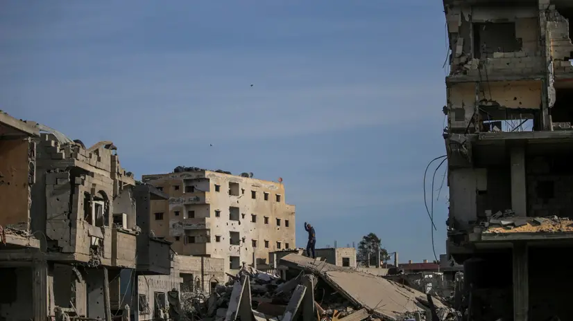 epa11836372 An internally displaced Palestinian man stands atop the ruins of his house in Rafah, southern Gaza Strip, 19 January 2025, amid a ceasefire between Israel and Hamas. Israel and Hamas agreed on a hostage release deal and a Gaza ceasefire to be implemented on 19 January 2025. More than 46,000 Palestinians have been killed in the Gaza Strip, according to the Palestinian Ministry of Health, since Israel launched a military campaign in the strip in response to a cross-border attack led by the Palestinian militant group Hamas on 07 October 2023, in which about 1,200 Israelis were killed and more than 250 taken hostage. EPA/MOHAMMED SABER