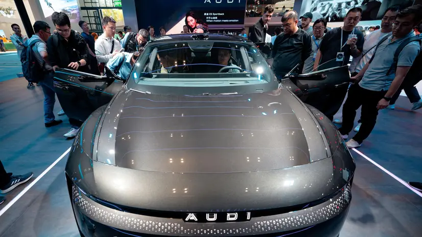 epa12049068 Visitors watch an A5 Sportback vehicle on display on Audi booth during the Auto Show, in Shanghai, China, 23 April 2025. The 21st Shanghai International Automobile Industry Exhibition will be held from 23 April to 02 May featuring over 70 automakers and 100 new models. EPA/ALEX PLAVEVSKI