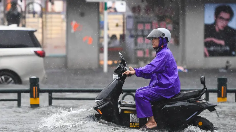 epa12249766 A delivery man drives a motorbike through a flooded area in Haikou, Hainan Province, China, 20 July 2025. Typhoon Wipha, the sixth typhoon of the year, made landfall near Jiangmen City in south China's Guangdong Province around 5:50 p.m., according to the Guangdong provincial meteorological observatory. Hainan raised its emergency response for flood and typhoon control from Level IV to Level III, as strong winds and rainstorms are expected to impact the island province. EPA/XINHUA / Yang Guanyu CHINA OUT / UK AND IRELAND OUT / MANDATORY CREDIT EDITORIAL USE ONLY