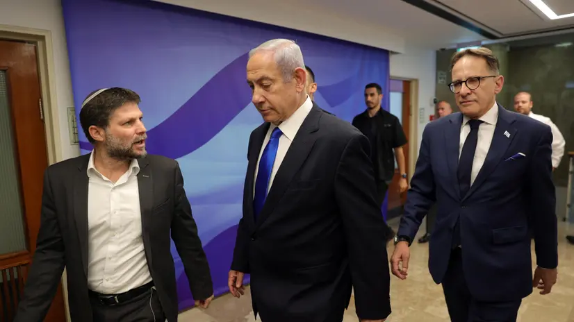 epa10710396 Israeli Prime Minister Benjamin Netanyahu (C) speaks with Finance Minister Bezalel Smotrich (L) during the weekly cabinet meeting in the prime minister's office in Jerusalem, 25 June 2023. EPA/ABIR SULTAN / POOL