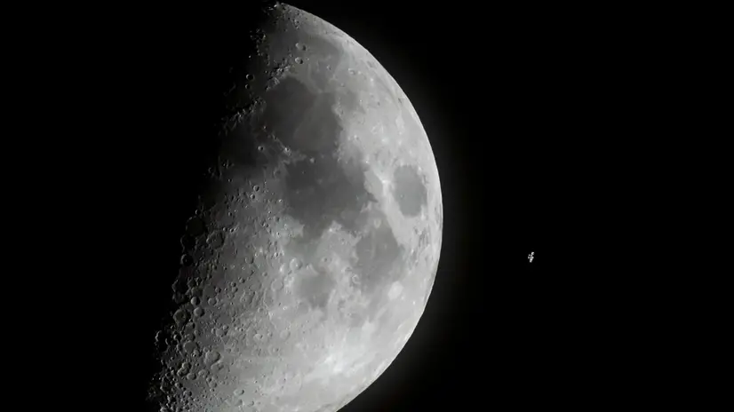 epa10550002 The International Space Station (ISS) passes in front of the Moon as captured near Buzitka, southern Slovakia, 29 March 2023 (issued 30 March 2023). EPA/Peter Komka HUNGARY OUT
