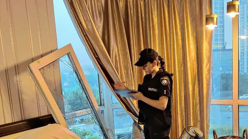 epa12267798 A handout photo made available by the National Police of Ukraine shows a police officer recording damages at a damaged flat in a residential building hit in a drone strike in Kyiv, Ukraine, 28 July 2025, amid the Russian invasion. At least eight people were injured, including one child, in Kyiv after Russian forces launched an overnight large-scale combined attack. EPA/NATIONAL POLICE OF UKRAINE / HANDOUT HANDOUT EDITORIAL USE ONLY/NO SALES