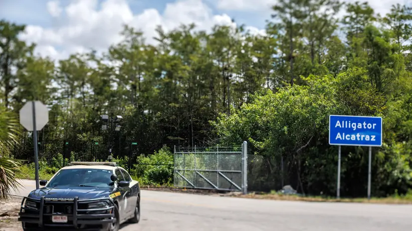 epa12253947 A police car guards the new detention center Alligator Alcatraz's entrance in Ochopee, Florida, USA, 22 July 2025. Alligator Alcatraz is an immigration detention facility in southern Florida's Everglades, surrounded by Everglade's wildlife like alligators, Florida panthers and pythons, and snakes as a natural deterrent. EPA/CRISTOBAL HERRERA-ULASHKEVICH