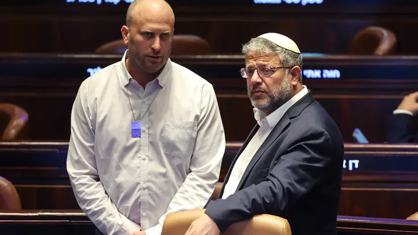 epa12255703 Israeli Knesset members Yitzhak Kroizer (L) and Itamar Ben-Gvir (R) attend a plenary session to vote on a bill for applying Israeli sovereignty over the West Bank territory, at the Knesset, the Israeli parliament, in Jerusalem, 23 July 2025. The bill, submitted by the Religious Zionist Party, calls for the imposition of Israeli sovereignty over the occupied West Bank, and the use of 'Judea and Samaria' instead of West Bank in Israel's legislation. EPA/ABIR SULTAN