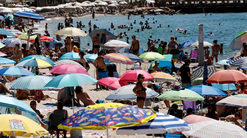 epa12273261 People enjoy the sun on a beach in Antibes, southern France, 30 July 2025. Temperatures reached up to 32 degrees Celsius in Antibes. EPA/SEBASTIEN NOGIER