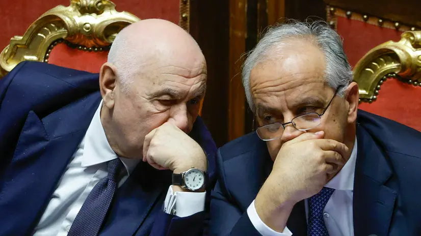 Italy's Justice Minister Carlo Nordio (L) and Interior Minister Matteo Piantedosi react during a government briefing over the case of Libyan General Osama Najim Almasri, at the Senate, Rome, Italy, 05 February 2025. On 21 January the Italian government released and repatriated Almasri after a brief detention over an International Criminal Court (ICC) arrest warrant. The general is wanted by the ICC over allegations of war crimes and crimes against humanity. ANSA/FABIO FRUSTACI