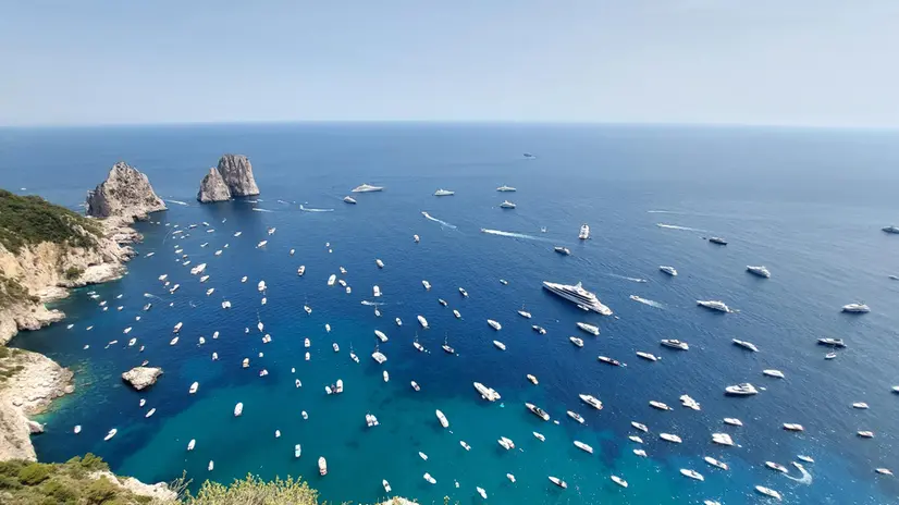 Summer in Capri, Faraglioni's rocks the favourite destination for the boats, 18 June 2023. ANSA/GIUSEPPE CATUOGNO (turismo, sud, mare, vacanza, tempo libero, generica, simbolica, barche, lusso, estate)