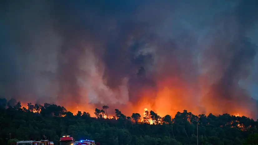 epa12287327 Firefighting crews are deployed to battle a forest fire in Saint-Laurent-de-la-Cabrerisse, Aude department, France, 06 August 2025. Some 16,000 hectares have been burned so far and at least one person died in the wildfire in southern France. EPA/PHILIPPE MAGONI
