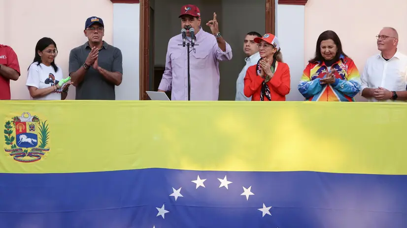 epa12269467 Venezuelan President Nicolas Maduro (C) speaks at a march celebrating the first anniversary of his second reelection, in Caracas, Venezuela, 28 July 2025. EPA/Ronald Peña R