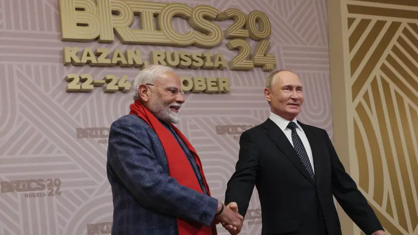 epa11675456 Russian President Vladimir Putin (R) shakes hands with Indian Prime Minister Narendra Modi during a welcoming ceremony before an informal dinner on sidelines of the BRICS 2024 Summit in Kazan, Russia, 22 October 2024. The BRICS summit takes place from 22 to 24 October and is expected to be the largest foreign policy event ever held in Russia. EPA/MAXIM SHIPENKOV