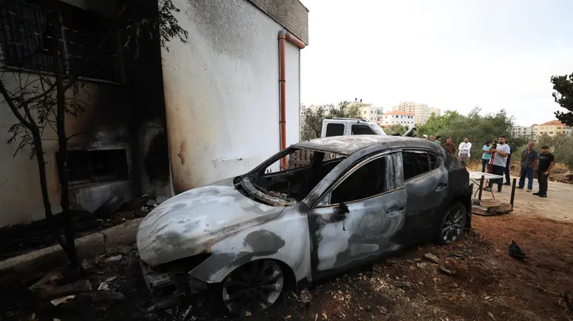 epa12274119 Palestinians inspect burned vehicles after an attack by Israeli settlers in Silwad village near the West Bank city of Ramallah, 31 July 2025. According to the Palestinian news agency Wafa, one person was killed in the early-morning attack and at least eight vehicles were set on fire. EPA/ALAA BADARNEH