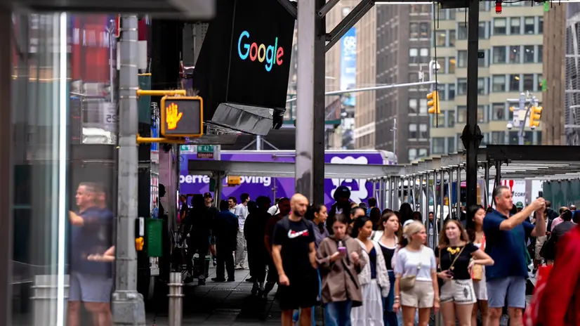epa12277765 People walk past the Google logo displayed at the Nasdaq headquarters in Times Square, in New York, New York, USA, 01 August 2025. US and global markets are down following US President Trump's sweeping tariff hikes on dozens of countries. EPA/ANGELINA KATSANIS
