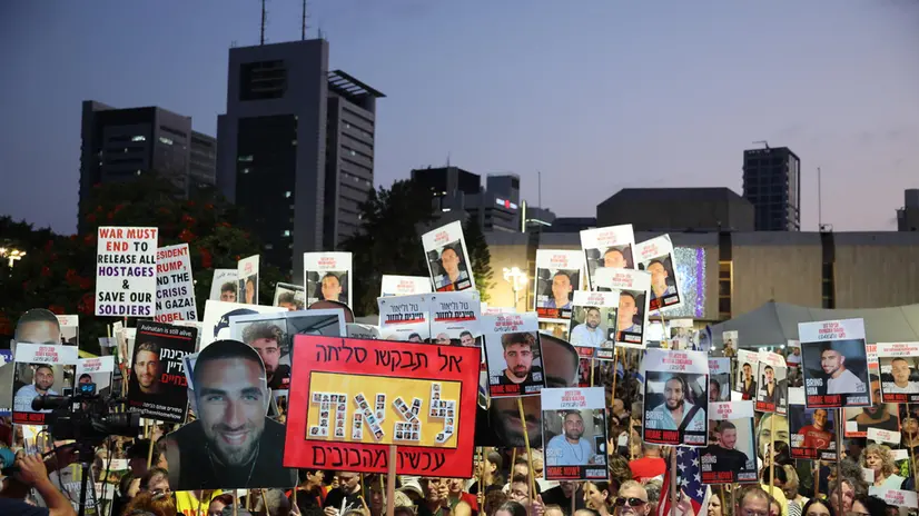 epa12291369 People attend a protest with pictures of Israeli hostages held by Hamas in Gaza calling the government to sign a hostages release and ceasefire deal, outside the Kirya military headquarters in Tel Aviv, Israel, 09 August 2025. According to the Israeli army (IDF) spokesperson, around 50 Israeli hostages remain in captivity in the Gaza Strip, including the bodies of at least 30 confirmed dead. EPA/ABIR SULTAN
