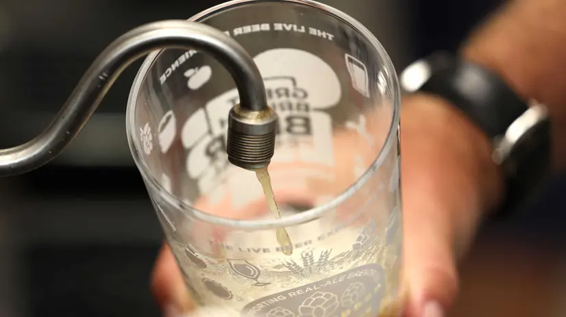 epa10779924 Beer is poured at the Great British Beer Festival in London Britain, 01 August 2023. The UK government is now taxing all alcohol based on its strength, rather than the previous categories of wine, beer, spirits, and ciders. The increase will see duty rise by 44p on a bottle of wine, a bottle of gin or vodka will rise by about 90p. Duty on draught pints across the UK will be cut by 11p. EPA/NEIL HALL