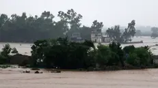 epa12243306 Floodwaters surround a partially submerged house during heavy monsoon rains at the Ladian village in Rawalpindi, Pakistan, 17 July 2025. Heavy monsoon rains continue to pound Pakistan, posing risks of flash floods, landslides, and urban flooding across several provinces. EPA/SOHAIL SHAHZAD
