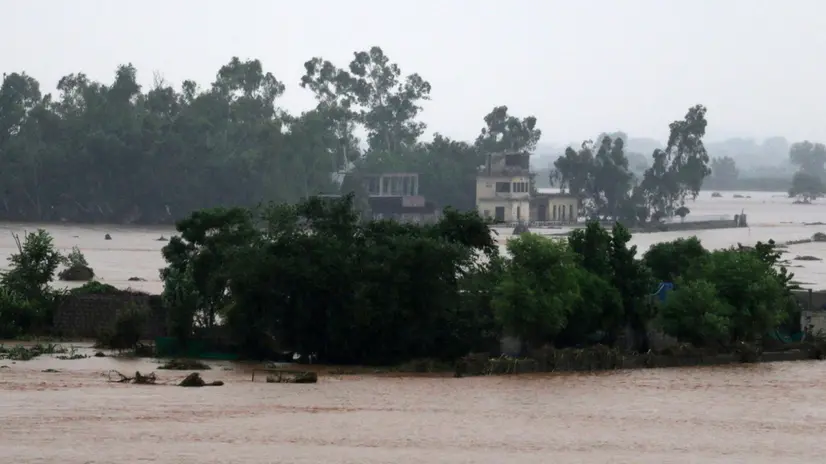 epa12243306 Floodwaters surround a partially submerged house during heavy monsoon rains at the Ladian village in Rawalpindi, Pakistan, 17 July 2025. Heavy monsoon rains continue to pound Pakistan, posing risks of flash floods, landslides, and urban flooding across several provinces. EPA/SOHAIL SHAHZAD