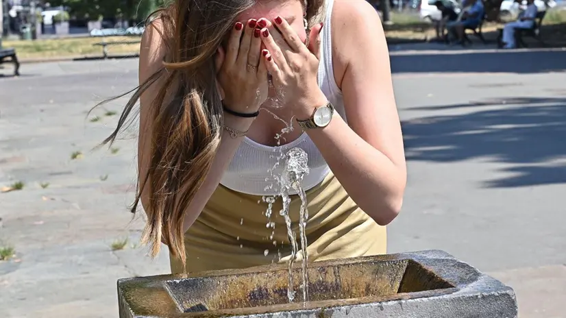 Una ragazza cerca refrigerio in una fontana - Foto Ansa/Alessandro Di Marco © www.giornaledibrescia.it