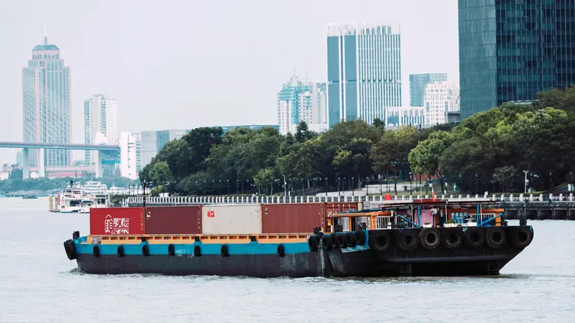 epa12287900 A cargo boat with containers sails on Huangpu River in Shanghai, China, 07 August 2025. Trump on 06 August hinted at new potential tariffs on China, similar to those imposed on India over Russian oil purchase. EPA/ALEX PLAVEVSKI