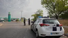 epa12294774 Local police stand by at a gas station in Tres Cantos, Madrid, Spain, 12 August 2025. A forest fire was declared late on 11 August in Tres Cantos, forcing the evacuation of three housing estates in the area. A 50-year-old man injured in the fire died on 12 August as a result of his injuries, while an 83-year-old man remains in hospital EPA/ZIPI